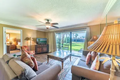 a living room with a couch and a table at Edgewater Villa 2708 'Lost Shaker of Salt' in Panama City Beach