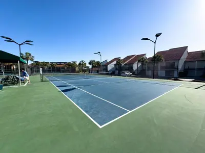 a tennis court with two people on it at Edgewater Villa 2708 'Lost Shaker of Salt' in Panama City Beach