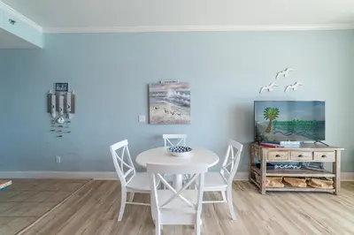 a dining room with a white table and chairs at Laketown Wharf 2117 'High Tide' in Panama City Beach