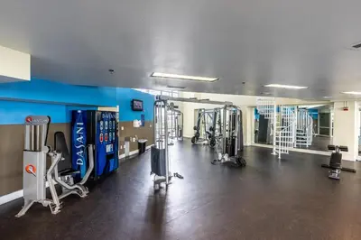 a gym with several treadmills and machines in a room at Laketown Wharf 2117 'High Tide' in Panama City Beach
