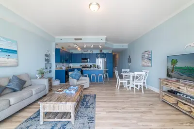 a living room with a couch and a table at Laketown Wharf 2117 'High Tide' in Panama City Beach