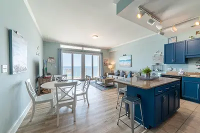 a kitchen and living room with a table and chairs at Laketown Wharf 2117 'High Tide' in Panama City Beach