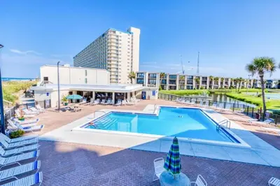 a large swimming pool in front of a building at Sugar Beach B04 'Seaside Escape' in Panama City Beach