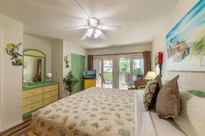 a bedroom with a bed and a ceiling fan at Sugar Beach B04 'Seaside Escape' in Panama City Beach