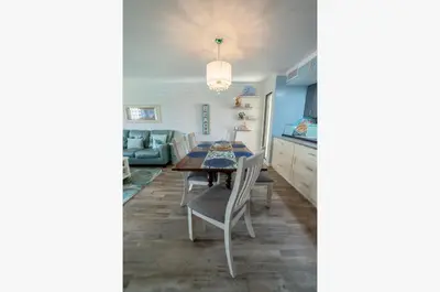 a kitchen and dining room with a table and chairs at Edgewater Villa 0912 'Villa de sol' in Panama City Beach
