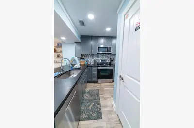 a kitchen with a sink and a stove top oven at Edgewater Villa 0912 'Villa de sol' in Panama City Beach