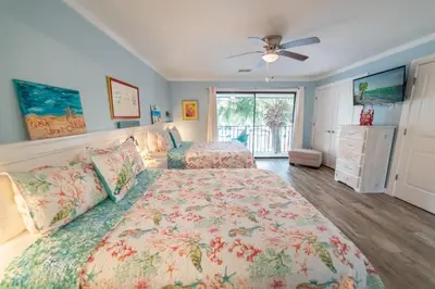 a bedroom with two beds and a ceiling fan at Edgewater Villa 0912 'Villa de sol' in Panama City Beach