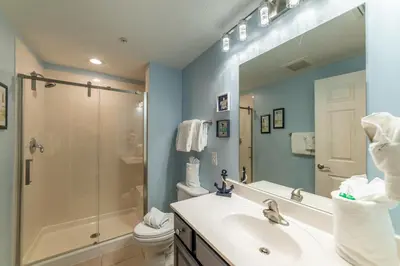 a bathroom with a sink and a shower and a toilet at Seychelles 1602 'Ocean Pearl' in Panama City Beach