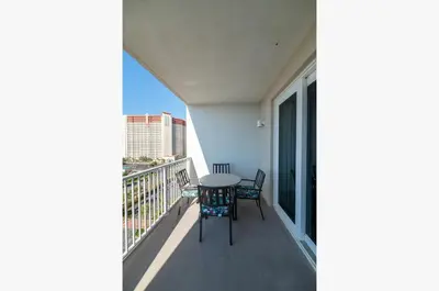 a balcony with a table and chairs on it at Laketown Wharf 816 'Tasty Waves PCB' in Panama City Beach