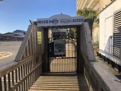 a gate to a water access sign on a building at Laketown Wharf 816 'Tasty Waves PCB' in Panama City Beach
