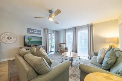 a living room with two couches and a table at Edgewater Villa 1104 'Sandy Feet Retreat' in Panama City Beach