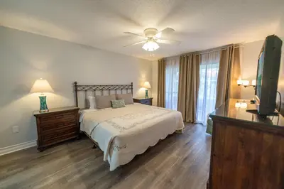 a bedroom with a bed and a flat screen tv at Edgewater Villa 1104 'Sandy Feet Retreat' in Panama City Beach