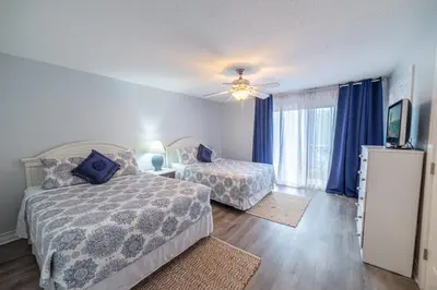 a bedroom with two beds and a ceiling fan at Edgewater Villa 1104 'Sandy Feet Retreat' in Panama City Beach