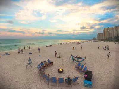 a group of people on a beach with the ocean at Sunbird 0503W 'Big O's Condo' in Panama City Beach