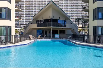 a large swimming pool in front of a building at Sunbird 0503W 'Big O's Condo' in Panama City Beach