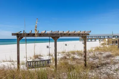 a swing on the beach with the ocean in the background at Sunbird 0503W 'Big O's Condo' in Panama City Beach