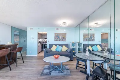a living room with a couch and a table at Sunbird 0503W 'Big O's Condo' in Panama City Beach