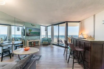 a living room with a view of the ocean at Sunbird 0503W 'Big O's Condo' in Panama City Beach