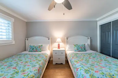 a bedroom with two beds and a lamp on a night stand at Regency Towers 0407 'The Memory Maker' in Panama City Beach