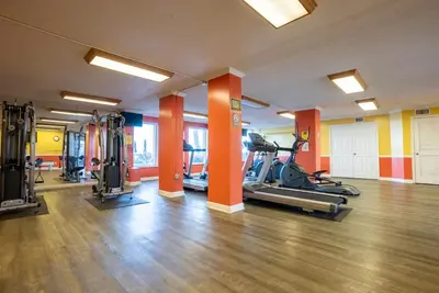 a gym with several treadmills and exercise bikes at Regency Towers 0407 'The Memory Maker' in Panama City Beach