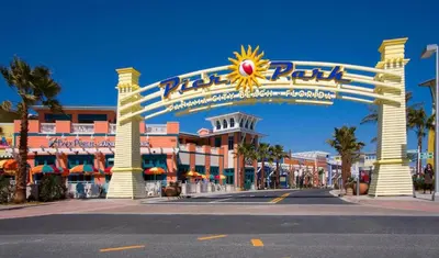 a large entrance to a resort with a sign at Regency Towers 0407 'The Memory Maker' in Panama City Beach
