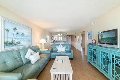 a living room with a couch and a tv at Regency Towers 0407 'The Memory Maker' in Panama City Beach