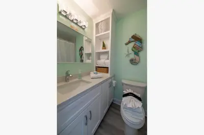 a bathroom with a sink and a toilet at Top Of The Gulf 625 'Beach Perfect' in Panama City Beach