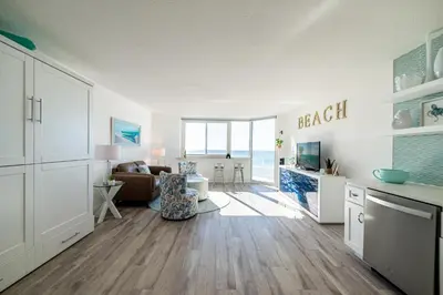 a living room with a couch and a table at Top Of The Gulf 625 'Beach Perfect' in Panama City Beach