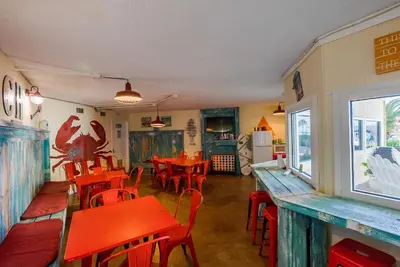 a restaurant with red tables and chairs in a room at Top Of The Gulf 625 'Beach Perfect' in Panama City Beach