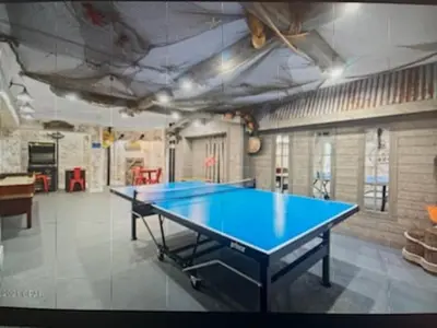 a ping pong table in the middle of a room at Top Of The Gulf 625 'Beach Perfect' in Panama City Beach