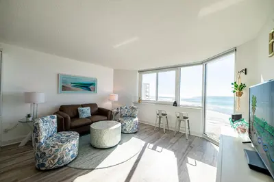 a living room with a couch and a table at Top Of The Gulf 625 'Beach Perfect' in Panama City Beach