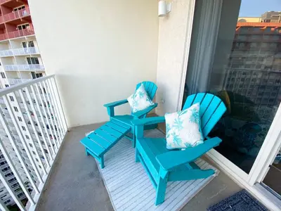 a pair of chairs sitting on a balcony at Shores of Panama 1925 'Sunset Shores' in Panama City Beach