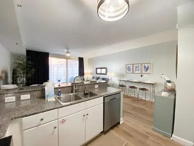 a kitchen with a sink and a counter top at Shores of Panama 1925 'Sunset Shores' in Panama City Beach