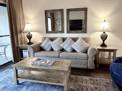 a living room with a couch and a table at Edgewater Villa 0608 'Sunny by the Sea' in Panama City Beach