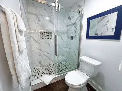 a bathroom with a shower and a toilet at Edgewater Villa 0608 'Sunny by the Sea' in Panama City Beach
