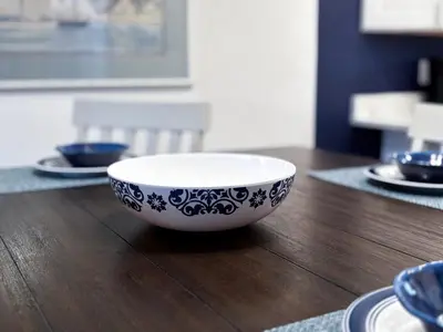 a blue and white bowl sitting on a wooden table at Edgewater Villa 0608 'Sunny by the Sea' in Panama City Beach