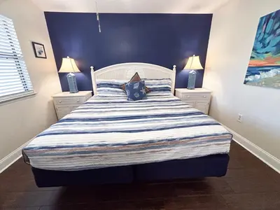 a bedroom with a large bed with two night stands at Edgewater Villa 0608 'Sunny by the Sea' in Panama City Beach