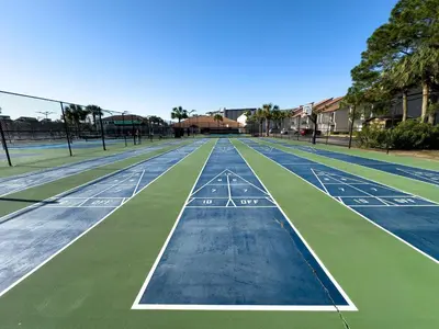 a tennis court with green and blue at Edgewater Villa 0608 'Sunny by the Sea' in Panama City Beach