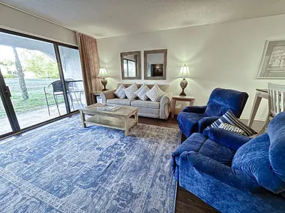 a living room with a couch and a table at Edgewater Villa 0608 'Sunny by the Sea' in Panama City Beach