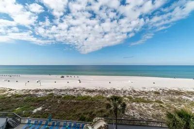 a view of the beach from the balcony of a resort at Edgewater 2-0409 'Paradise City' in Panama City Beach