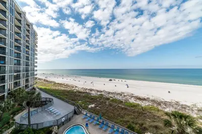 a view of the beach from the balcony of a resort at Edgewater 2-0409 'Paradise City' in Panama City Beach