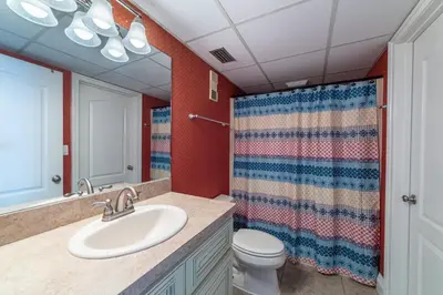a bathroom with a sink and a toilet at Edgewater 2-0409 'Paradise City' in Panama City Beach