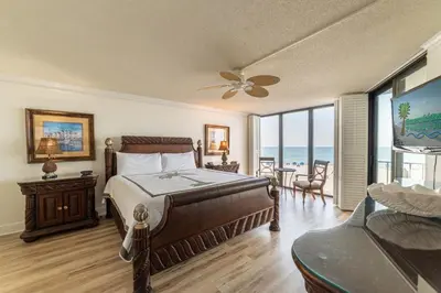 a bedroom with a bed and a view of the ocean at Edgewater 2-0203 'Beach Days' in Panama City Beach