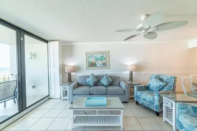 a living room with a couch and a table at Edgewater 2-0203 'Beach Days' in Panama City Beach