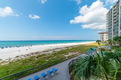a view of the beach from the balcony of a resort at Edgewater 2-0203 'Beach Days' in Panama City Beach