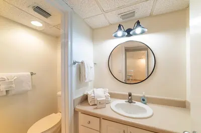a bathroom with a sink and a mirror at Edgewater 2-0203 'Beach Days' in Panama City Beach