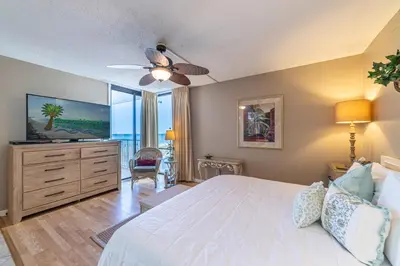 a bedroom with a bed and a flat screen tv at Edgewater W208 Beach Bungalow Bliss in Panama City Beach