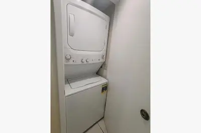a white microwave sitting on top of a refrigerator at Edgewater 3-0409 'Sunset Place' in Panama City Beach