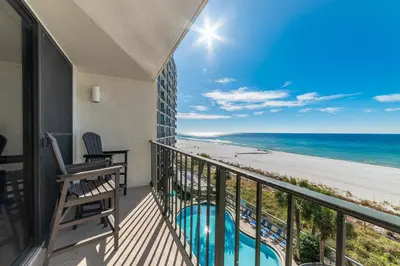 a balcony with a view of the beach at Edgewater 3-0409 'Sunset Place' in Panama City Beach