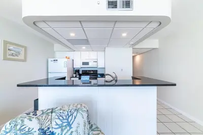 a kitchen with a black counter top in a room at Edgewater 3-0409 'Sunset Place' in Panama City Beach